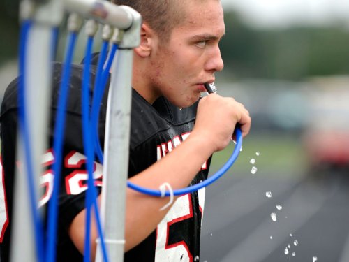 Kyle rehydrates on the sidelines.