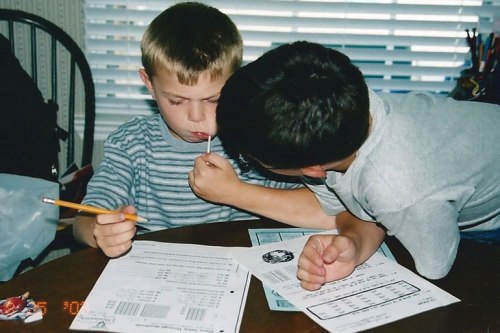 Older brother helps his younger sibling with his homework 10 years ago.