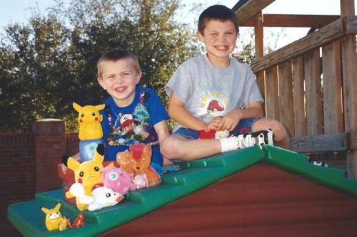 The boys on their play cottage in 1999 with their  Pokémon collection