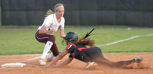 Alyssia slides into third base. Note that the ball is in the fielder’s glove.